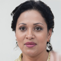 Joyful black adult female with medium  brown hair and brown eyes