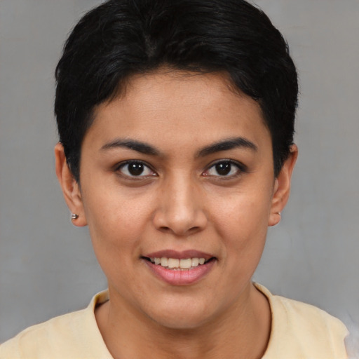 Joyful latino young-adult female with short  brown hair and brown eyes