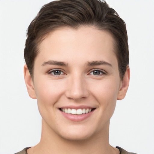 Joyful white young-adult female with short  brown hair and brown eyes