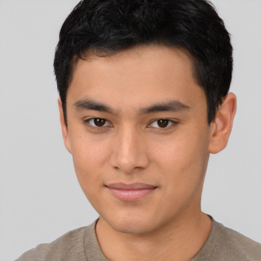 Joyful asian young-adult male with short  brown hair and brown eyes