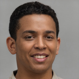 Joyful latino young-adult male with short  brown hair and brown eyes