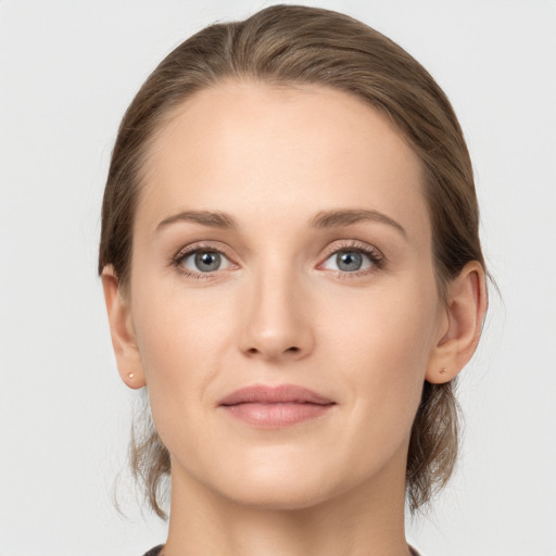 Joyful white young-adult female with medium  brown hair and grey eyes