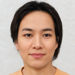 Joyful asian young-adult female with short  brown hair and brown eyes