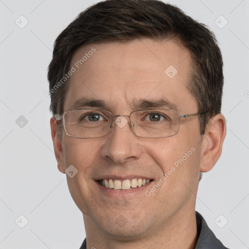 Joyful white adult male with short  brown hair and grey eyes