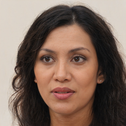 Joyful asian adult female with long  brown hair and brown eyes