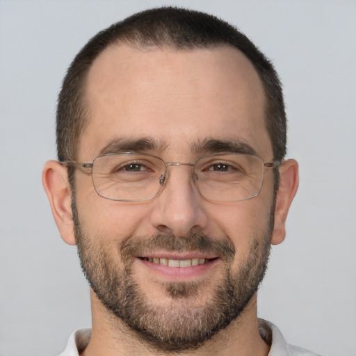 Joyful white adult male with short  brown hair and brown eyes