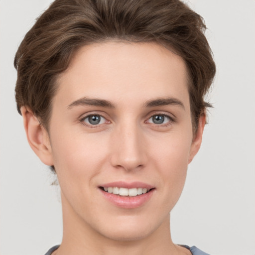 Joyful white young-adult female with short  brown hair and grey eyes