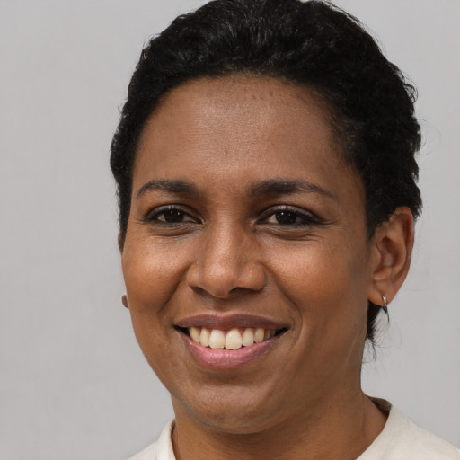 Joyful latino young-adult female with short  brown hair and brown eyes