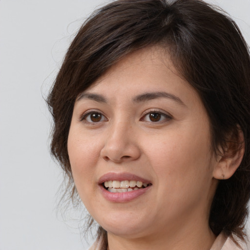 Joyful white young-adult female with medium  brown hair and brown eyes