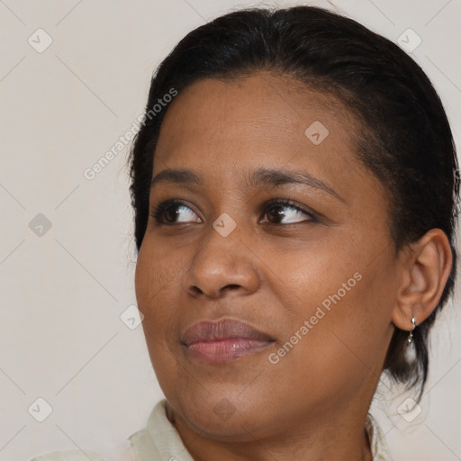 Joyful black young-adult female with medium  brown hair and brown eyes