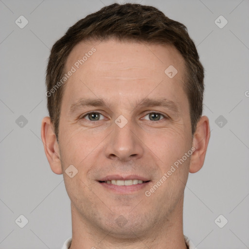 Joyful white adult male with short  brown hair and grey eyes