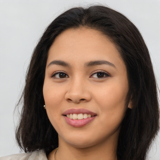Joyful asian young-adult female with long  brown hair and brown eyes