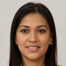 Joyful latino young-adult female with long  brown hair and brown eyes