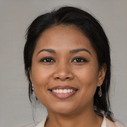 Joyful latino young-adult female with medium  brown hair and brown eyes