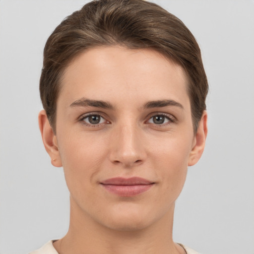 Joyful white young-adult female with short  brown hair and grey eyes