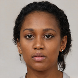 Neutral black young-adult female with medium  brown hair and brown eyes