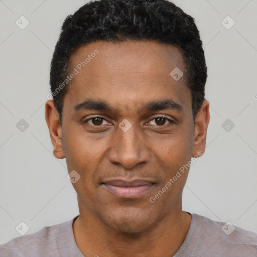 Joyful black young-adult male with short  black hair and brown eyes