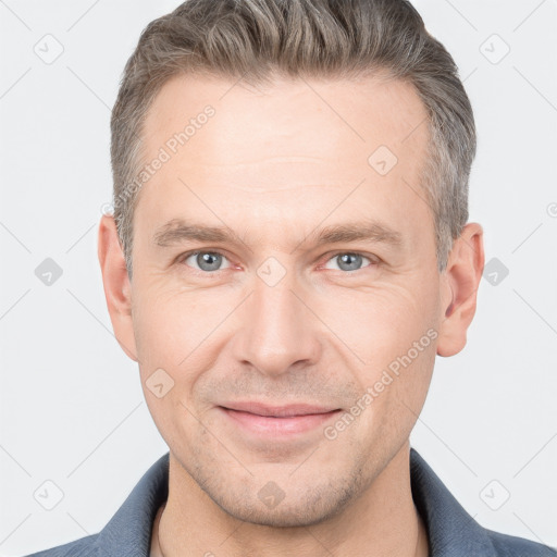 Joyful white adult male with short  brown hair and grey eyes