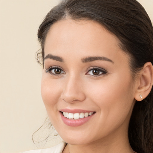 Joyful white young-adult female with long  brown hair and brown eyes