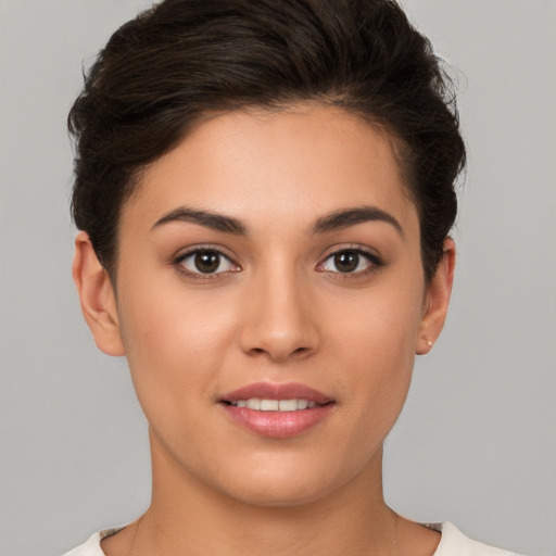 Joyful white young-adult female with short  brown hair and brown eyes