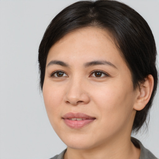 Joyful asian young-adult female with medium  brown hair and brown eyes