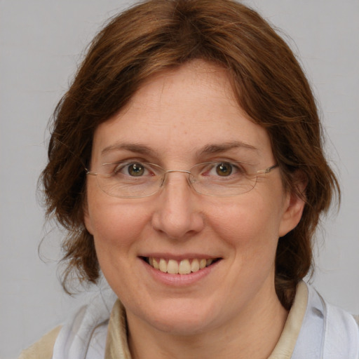 Joyful white adult female with medium  brown hair and blue eyes