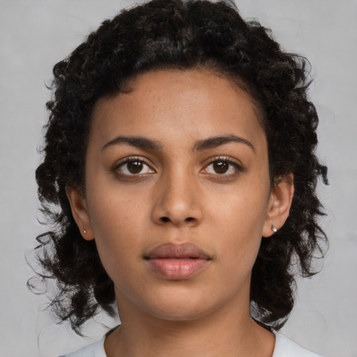 Neutral black young-adult female with medium  brown hair and brown eyes