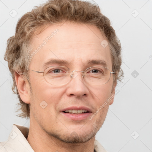 Joyful white adult male with short  brown hair and blue eyes