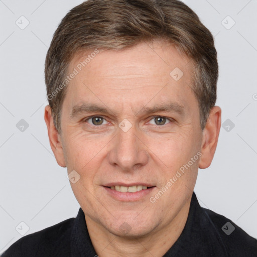 Joyful white adult male with short  brown hair and brown eyes