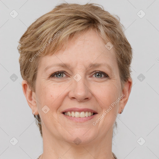 Joyful white adult female with short  brown hair and grey eyes