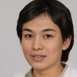 Joyful asian young-adult female with medium  brown hair and brown eyes