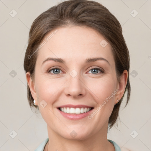 Joyful white young-adult female with medium  brown hair and grey eyes