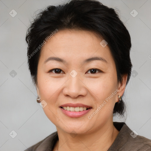 Joyful asian adult female with short  brown hair and brown eyes