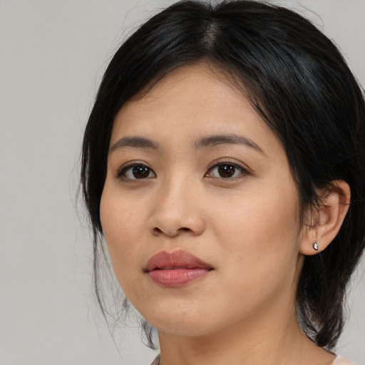 Joyful asian young-adult female with medium  black hair and brown eyes