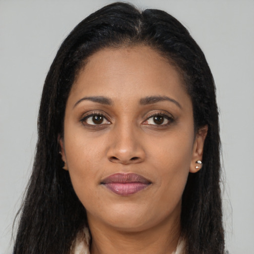 Joyful latino young-adult female with long  brown hair and brown eyes