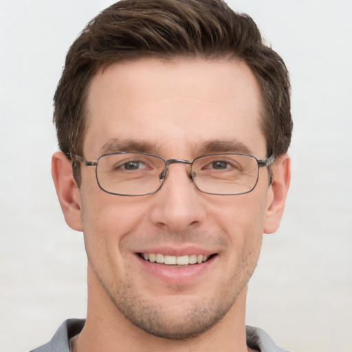 Joyful white adult male with short  brown hair and grey eyes