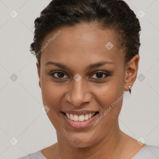 Joyful black young-adult female with short  brown hair and brown eyes