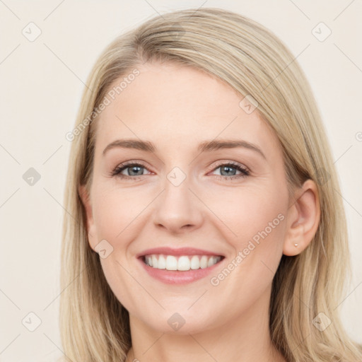 Joyful white young-adult female with long  brown hair and blue eyes