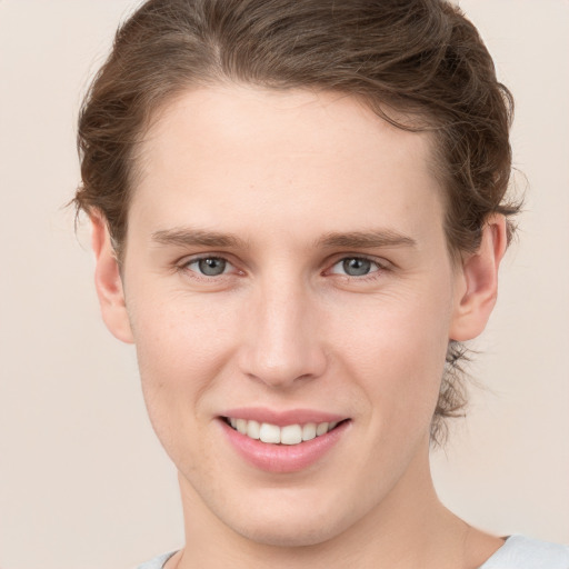 Joyful white young-adult female with short  brown hair and grey eyes