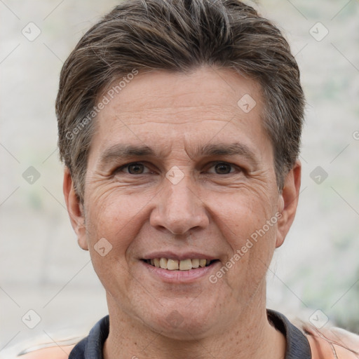 Joyful white adult male with short  brown hair and brown eyes