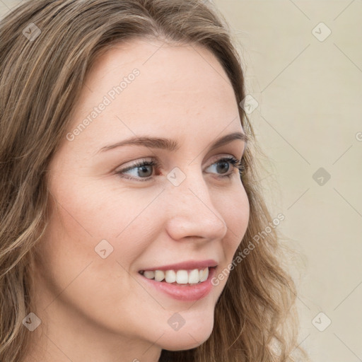 Joyful white young-adult female with long  brown hair and blue eyes