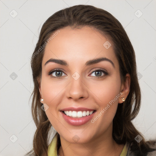 Joyful white young-adult female with long  brown hair and brown eyes