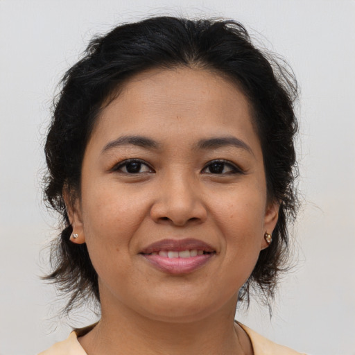Joyful asian young-adult female with medium  brown hair and brown eyes