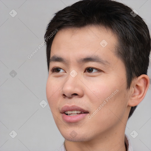 Joyful white young-adult male with short  black hair and brown eyes