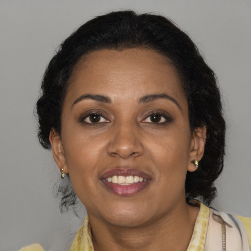 Joyful black young-adult female with medium  brown hair and brown eyes