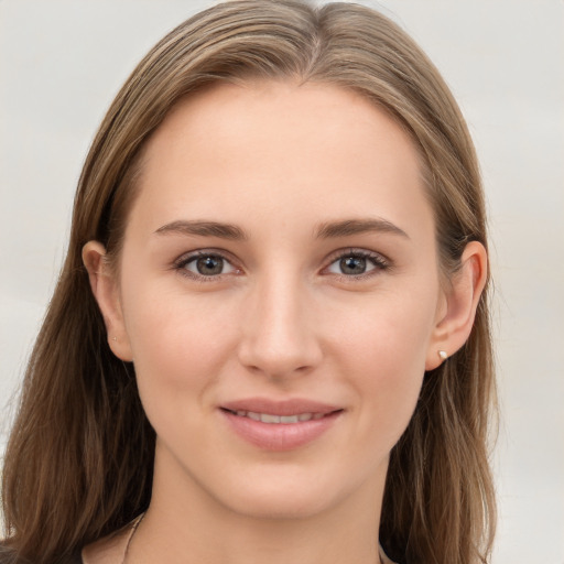 Joyful white young-adult female with long  brown hair and grey eyes