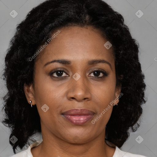 Joyful black adult female with medium  brown hair and brown eyes