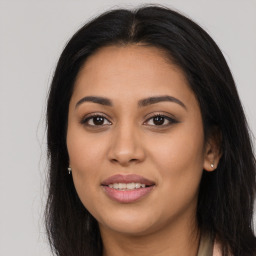 Joyful latino young-adult female with long  brown hair and brown eyes