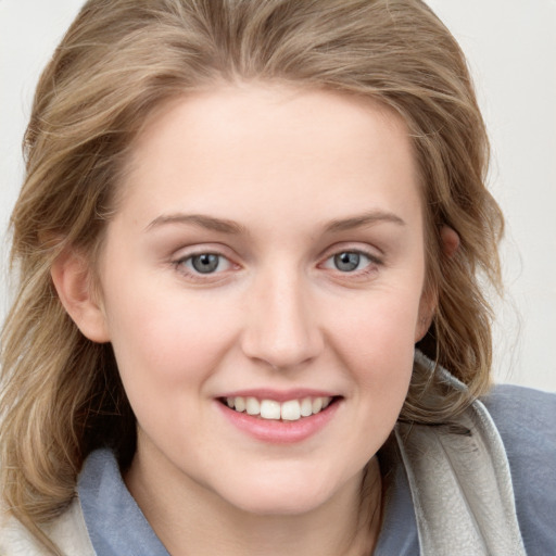 Joyful white young-adult female with medium  brown hair and blue eyes