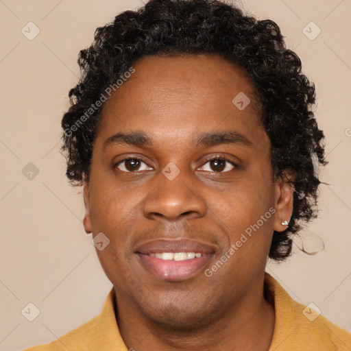 Joyful black young-adult male with short  black hair and brown eyes